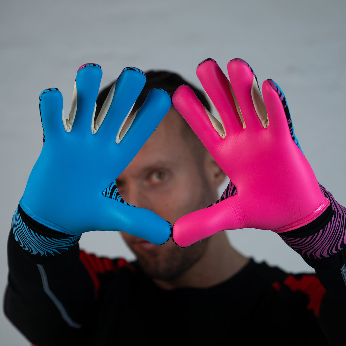 a photo of saviour gk pink and blue negative palm goalie gloves