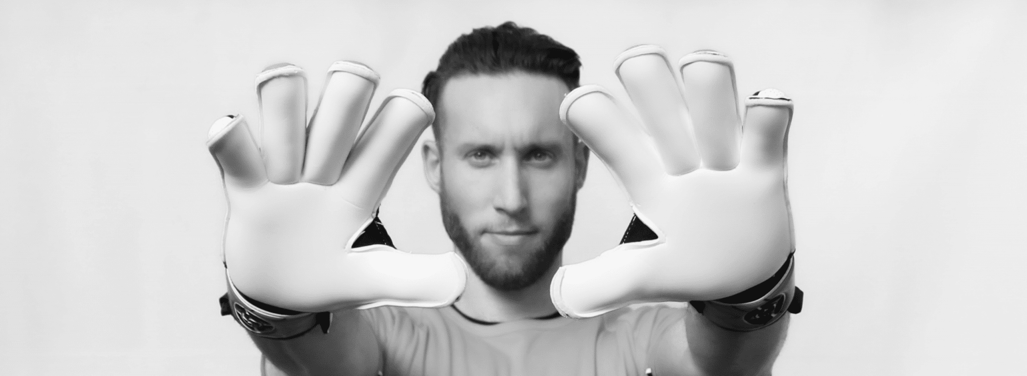 Close-up of a goalkeeper's hands wearing Saviour GK gloves, symbolizing the user agreement and product quality.