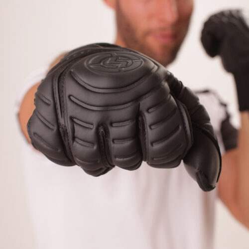 All-black blackout goalkeeper gloves with minimalist design.