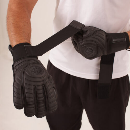 Minimalist blackout design goalkeeper gloves in black latex.