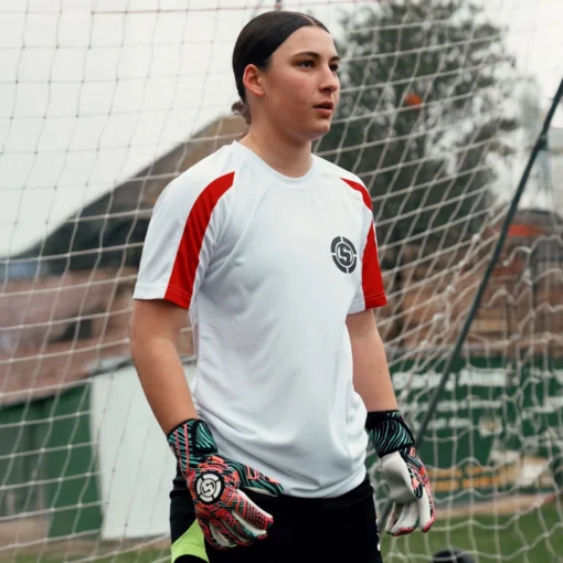 Sleek white goalkeeping t-shirt worn by a goalkeeper in action.