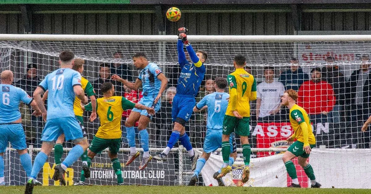 Goalkeeper jumping in mid-air during a jump with arms extended, demonstrating powerful arm movement and jumping technique.