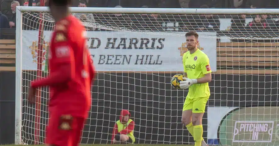 A former professional goalkeeper training on the field, emphasizing the importance of support, sacrifice, focus, mental strength, and hard work.