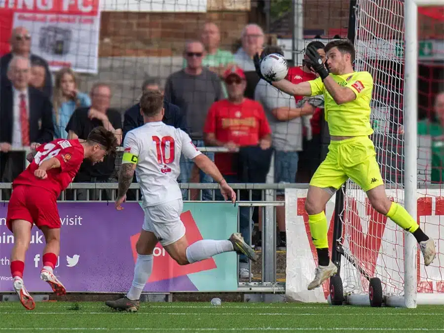 Goalkeeper setting up for a save during training, showcasing effective goalkeeper goal setting techniques.