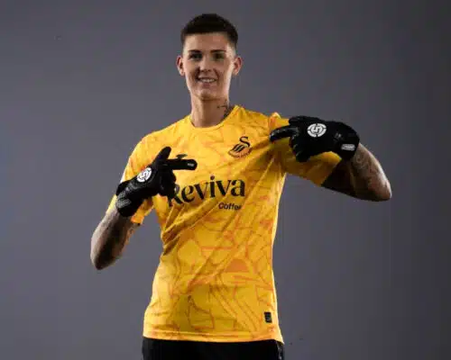 Charlotte Haynes, goalkeeper for Swansea City AFC Ladies, sponsored by SAVIOUR GK, standing confidently in her SAVIOUR GK gloves.