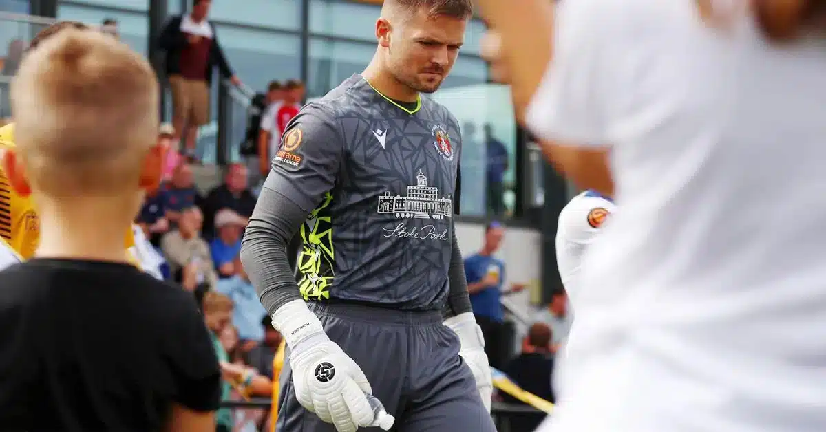 Goalkeeper standing resiliently after a tough game, showcasing goalkeeper mental recovery.