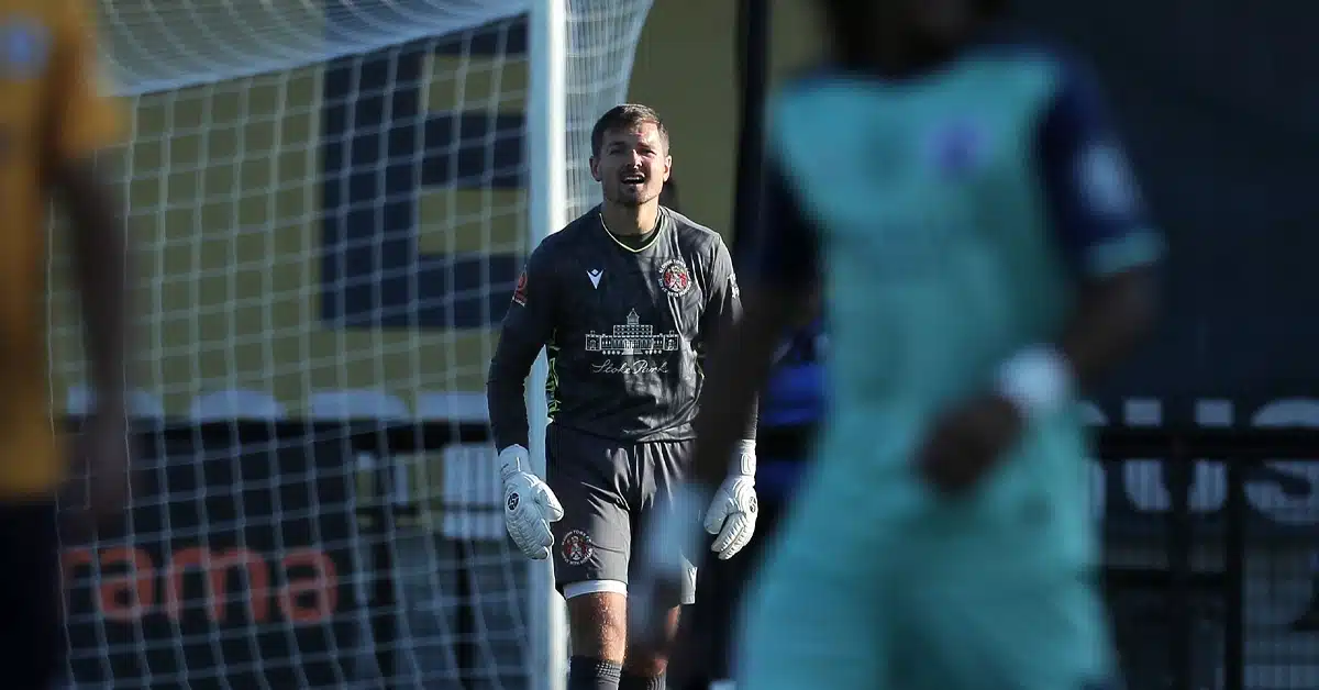 Goalkeeper readying for a save, embodying a winner's mindset on the field.