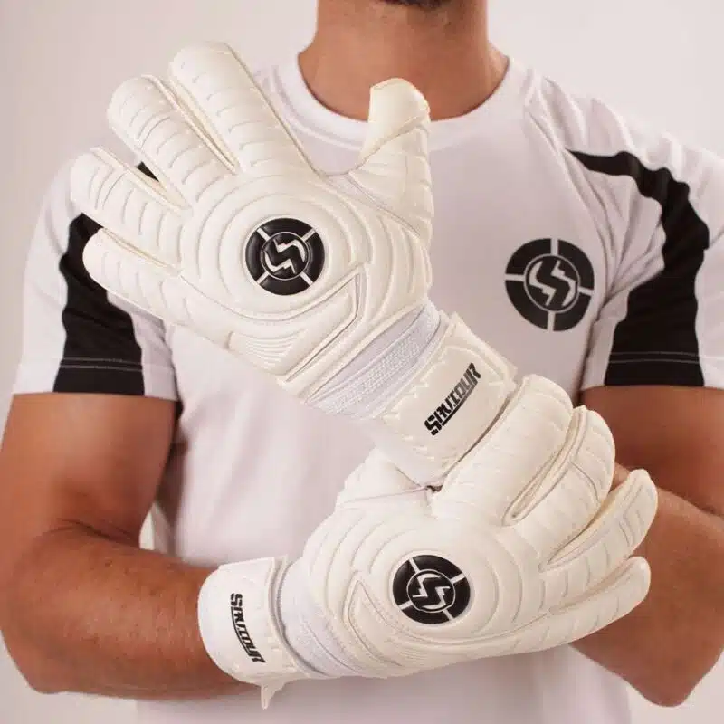 Youth goalkeeper gloves to make a save wearing Saviour Classic soccer gloves.