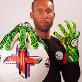 Young goalkeeper catching a ball confidently with good grip goalkeeper gloves