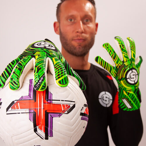 Young goalkeeper catching a ball confidently with good grip goalkeeper gloves