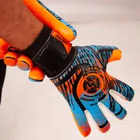 Young goalkeeper making a save in a match wearing specialized football goalie gloves for youth.