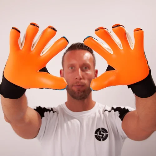 Goalkeeper showcasing enhanced grip with specialized goalkeeper gloves during a match.