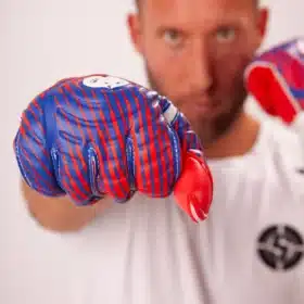 Goalkeeper wearing classic retro goalkeeper gloves, preparing for a save.