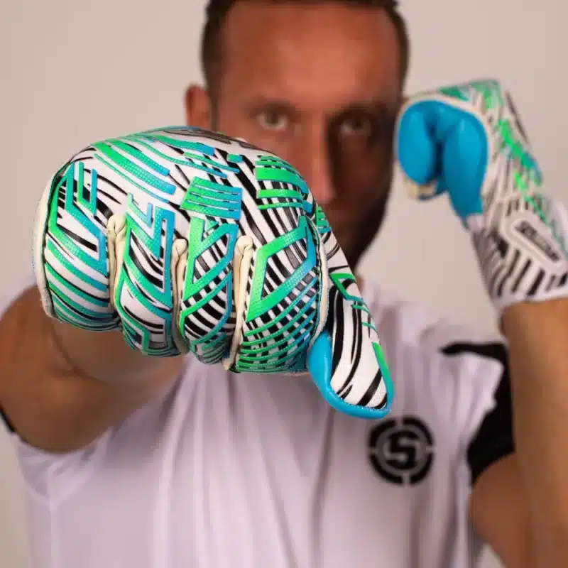 Front and back view of junior goalkeeper gloves with finger protection raised against the sky. The pros and cons of removable finger spine goalkeeper gloves