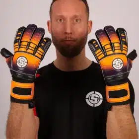 Orange and purple goal keeper gloves showing reinforced finger protection spines.